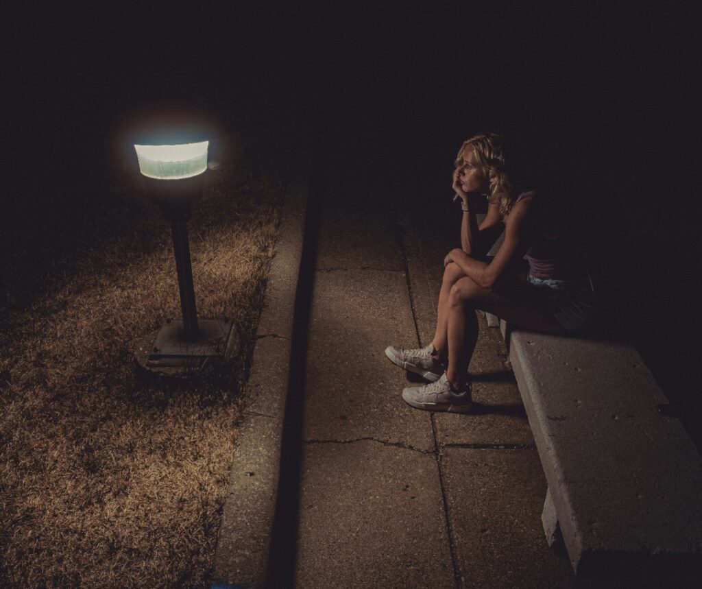 Woman sitting in the dark
